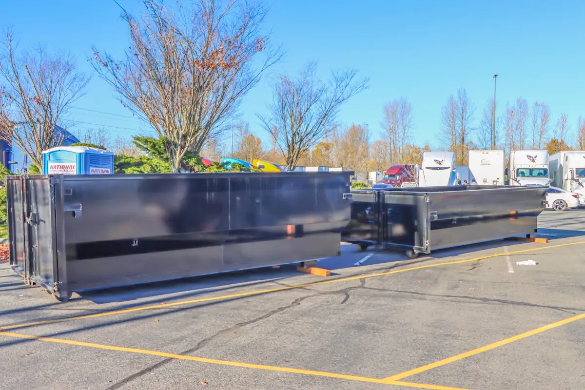 Professional dumpster rental service with roll-off container on residential driveway in Eustis